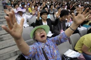 A South Korean Christian woman prays during a service to mark the 60th anniversary of the June 25 Korean War at the World Cup Stadium in Seoul, Tuesday, June 22, 2010. More than 30,000 Christians congregated for prayers for a peaceful solution over North Korea's nuclear weapons programs and hope for an early reunification of the divided Koreas. (AP Photo/Ahn Young-joon)